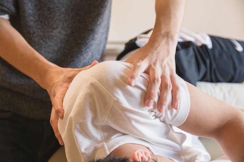 Illustrative physical therapy session with guided shoulder movement